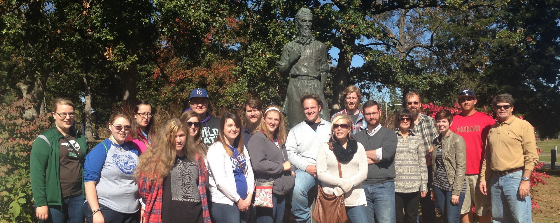 History department students and faculty with statue on trip